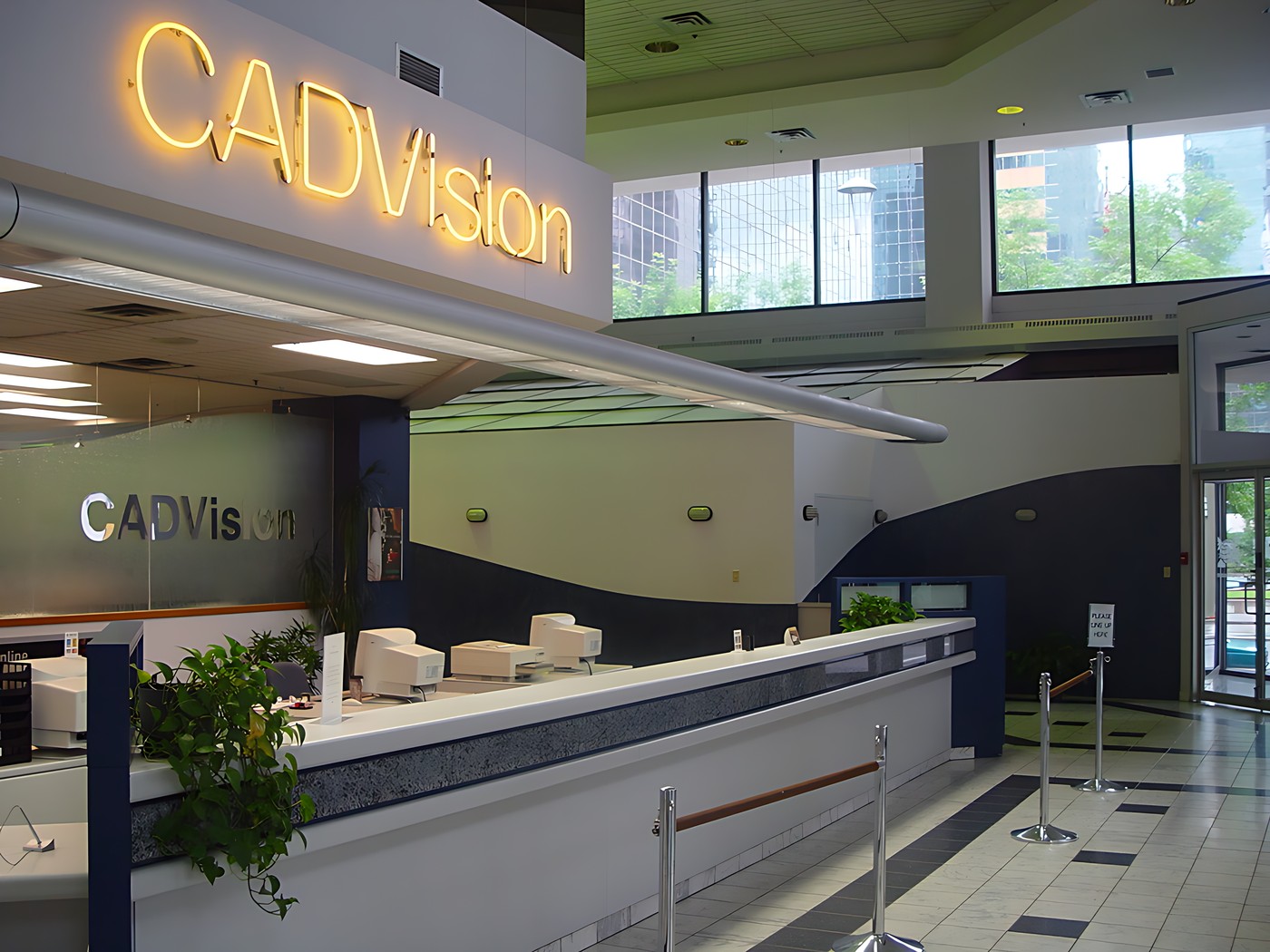 Entrance of a building with a large sign that reads "CADVISION" above th