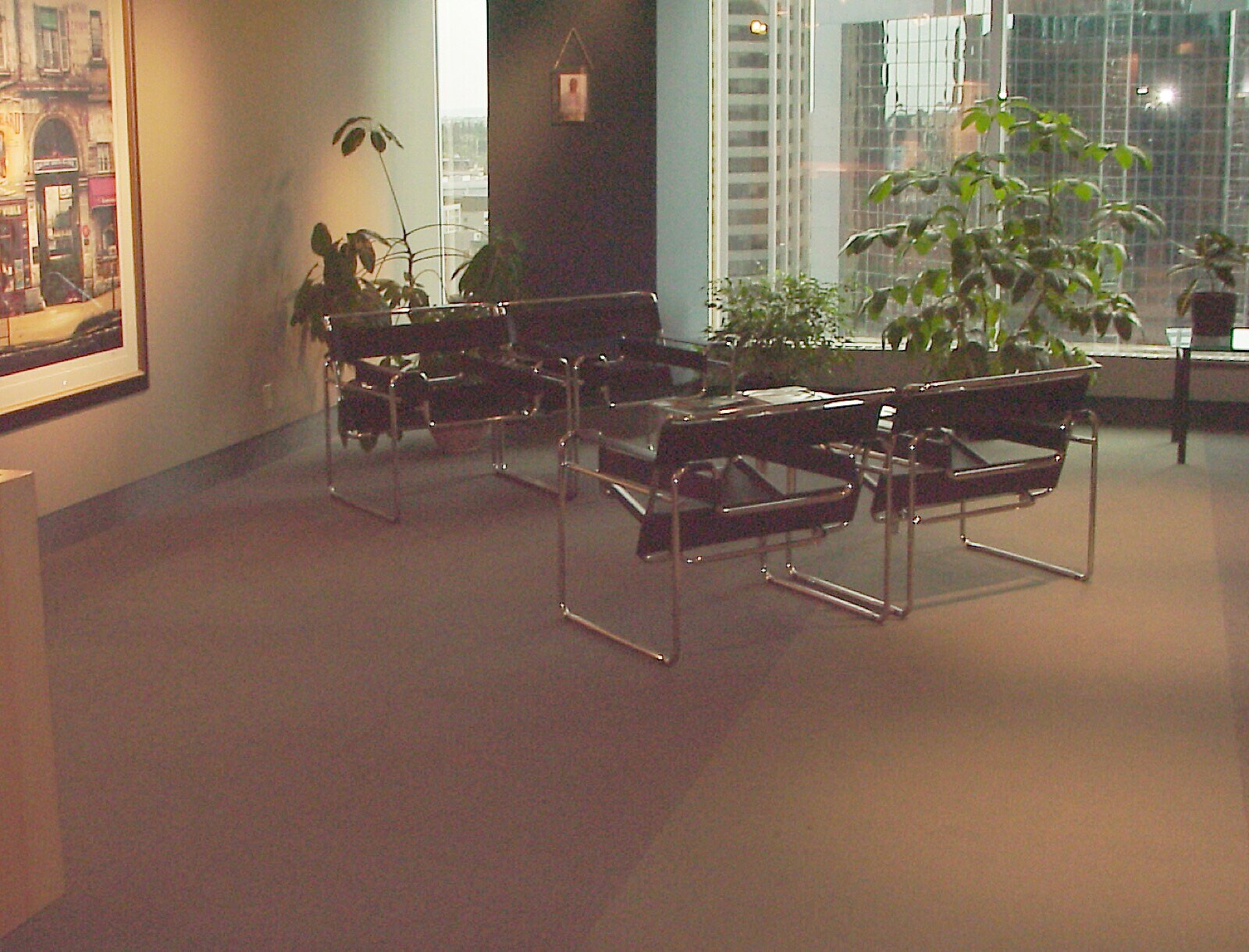 The waiting lounge — Wassily chairs and a downtown skyline