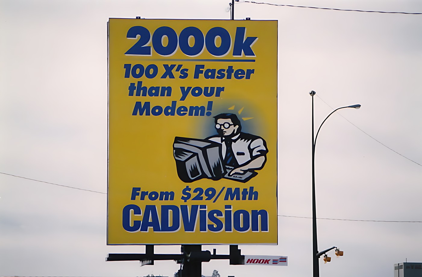 Photograph of a yellow billboard with blue text and an illustration of a
