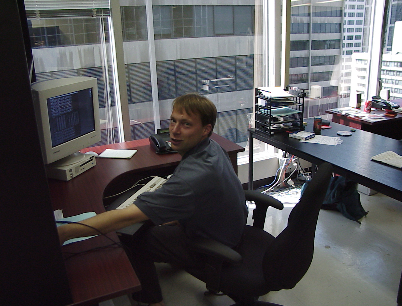 A corner desk with a downtown view